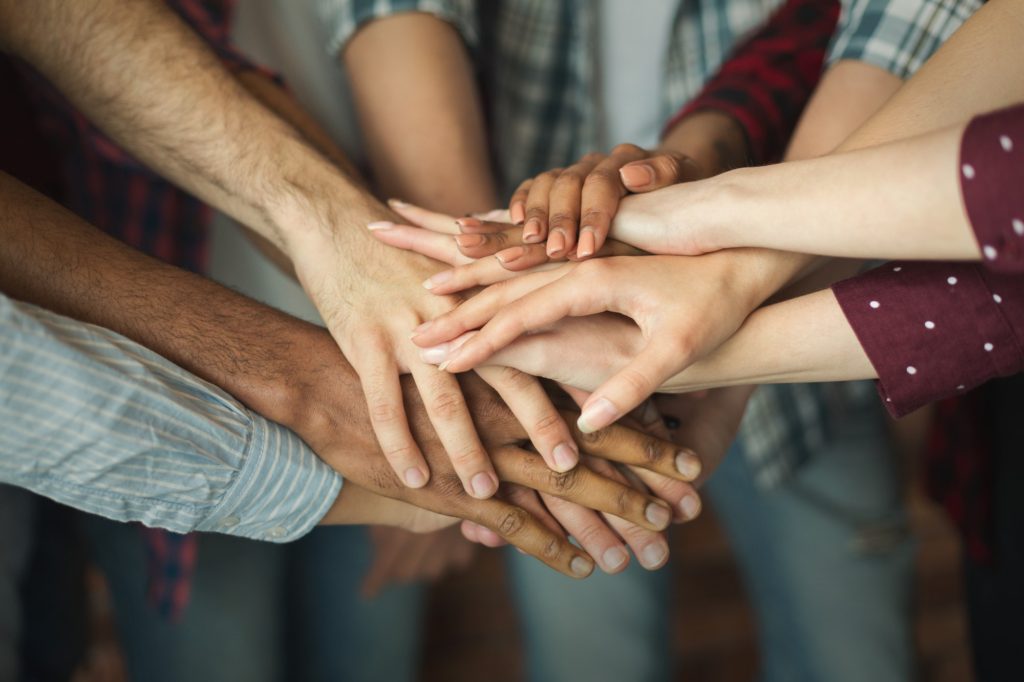 Group of friends holding hands together